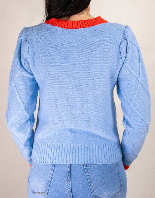 Jersey de rombos con manga abullonada azul claro y ribete naranja muestrarios de moda y ropa de mujer