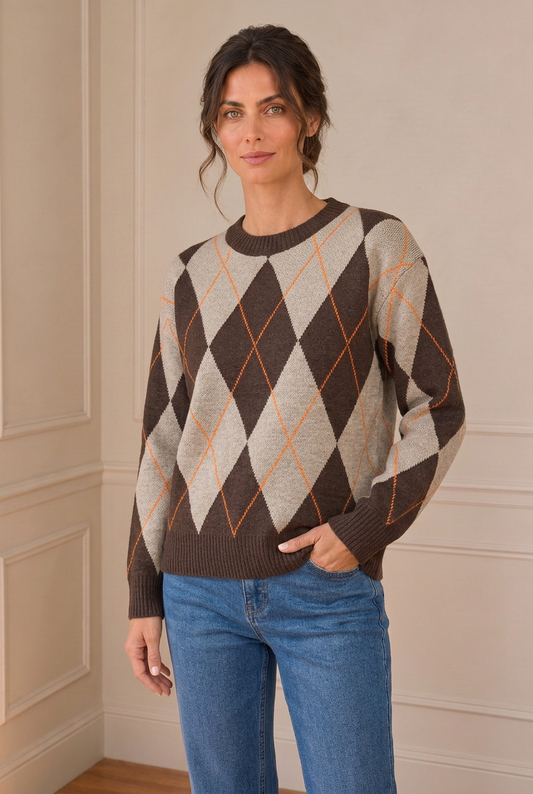 Modelo con jersey de rombos marrón y beige, vaquero y nueva postura